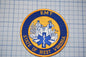 a patch with the text "EMT" and "STATE OF WEST VIRGINIA" on it, along with a blue and yellow design.