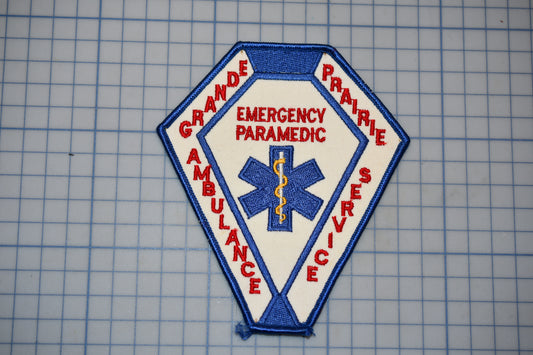 a patch with the words "EMERGENCY PARAMEDIC" and "AMBULANCE SERVICE" written on it, along with a medical symbol.