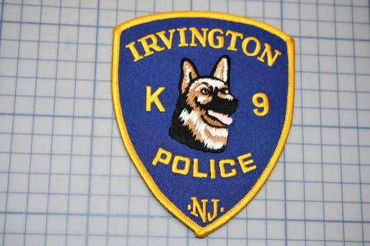 a k9 police badge on a cutting board