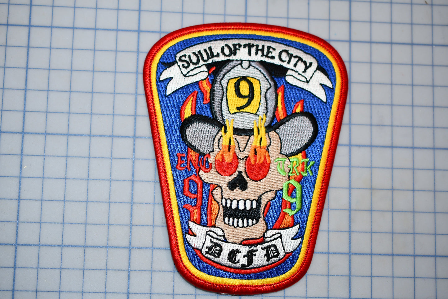 a colorful patch with a skull and flames, representing the "Soul of the City" fire department.