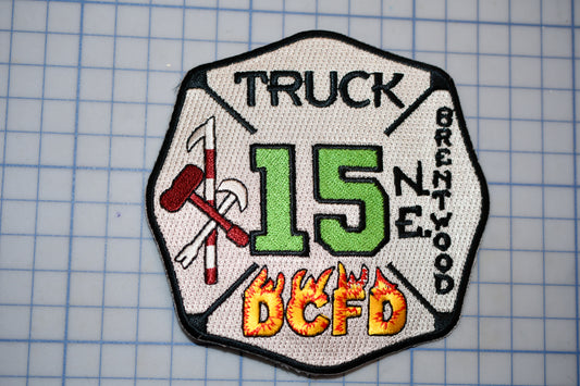 A fire department patch with the number 15 and the words "Truck" and "Brentwood" printed on it.
