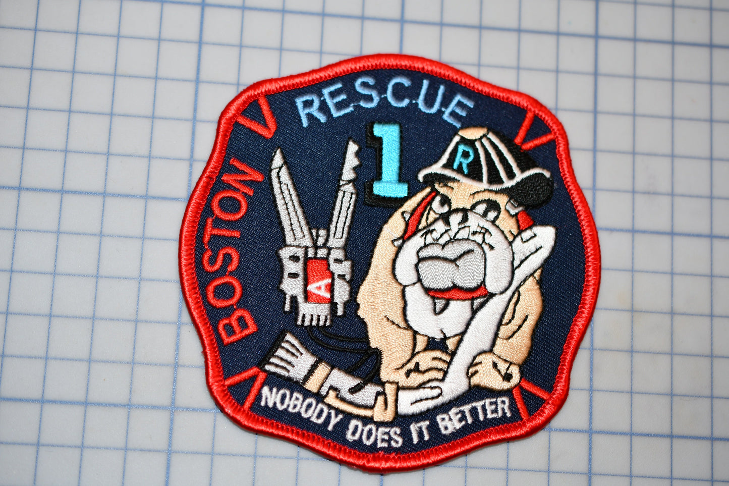 a patch with a cartoon dog and a firefighter, representing the Boston Rescue Fire Department.