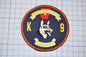 A circular patch with a dog's head and the text "Little Rock Police" on it, along with the number "9".