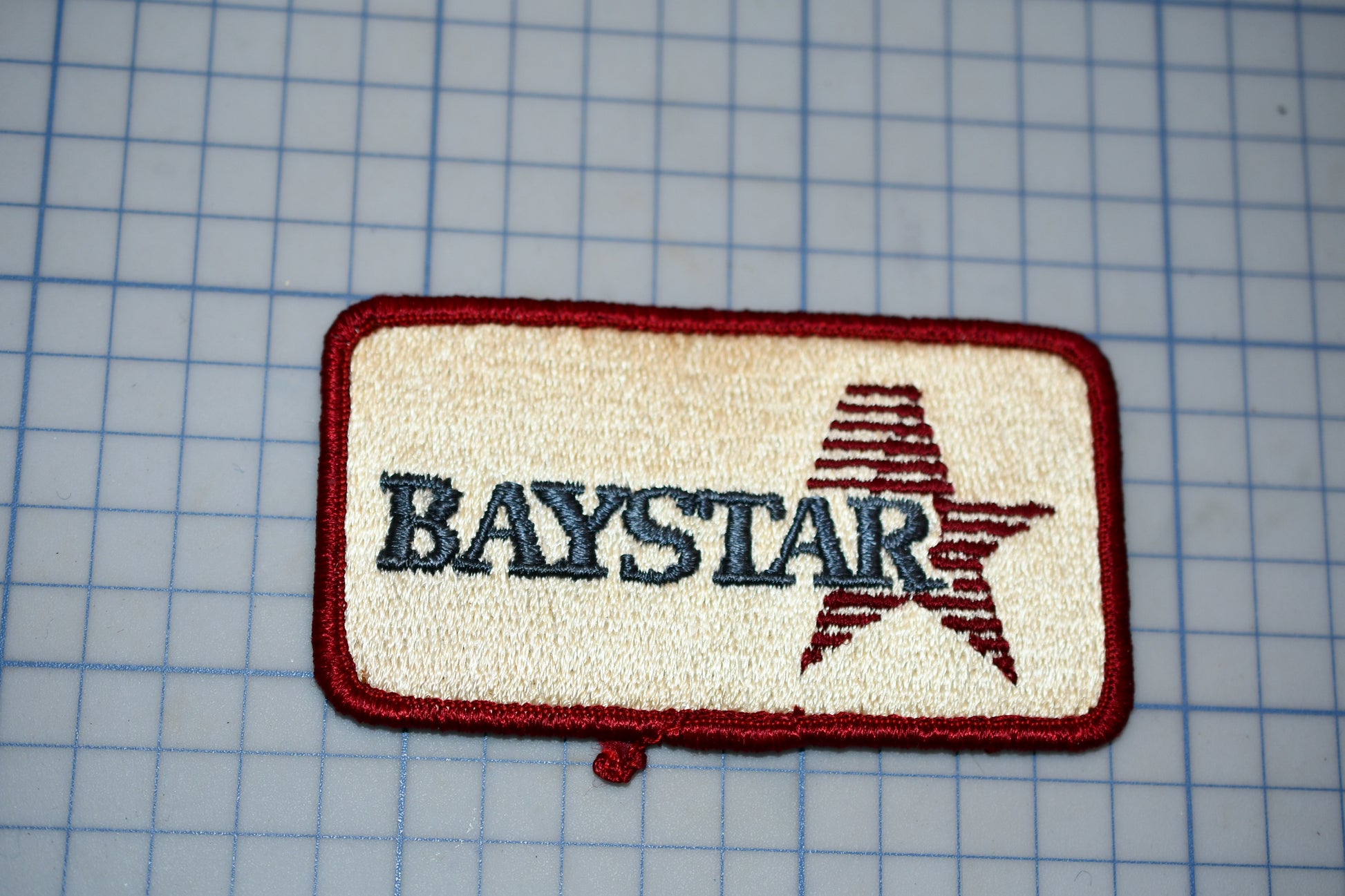 A red and beige patch with the word "BAYSTAR" printed on it, along with a red star symbol.