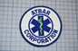a circular patch with the text "ATBAR CORPORATION" and a medical symbol, such as a cross or stethoscope, prominently displayed.