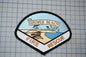 a patch with the text "GROVER BEACH FIRE RESCUE" and an illustration of a beach scene with mountains, a bird, and a body of water.