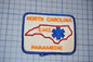 a patch with the text "NORTH CAROLINA EMT PARAMEDIC" and a blue star-shaped symbol, representing the emergency medical services of North Carolina.