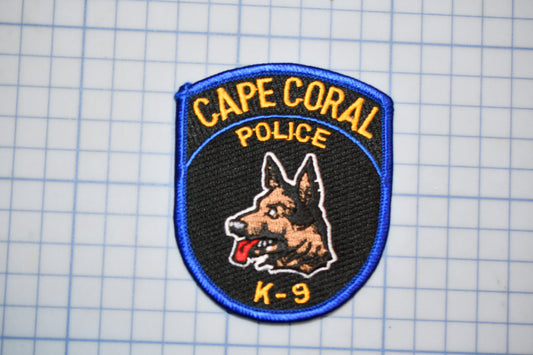 A Cape Coral Police K-9 unit patch is displayed against a grid background.