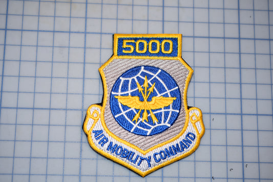 a military emblem with the number "5000" and the words "Air Mobility Command" written on it.