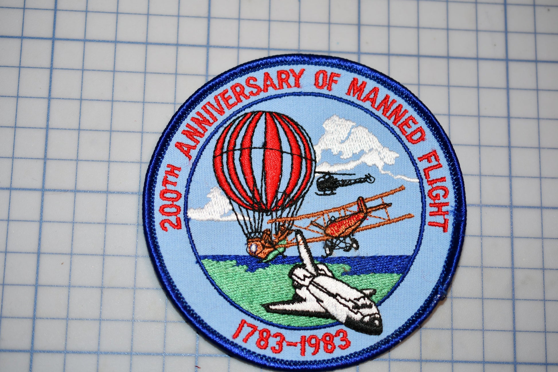 a patch with a picture of an airplane and a hot air balloon