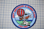 a patch with a picture of an airplane and a hot air balloon