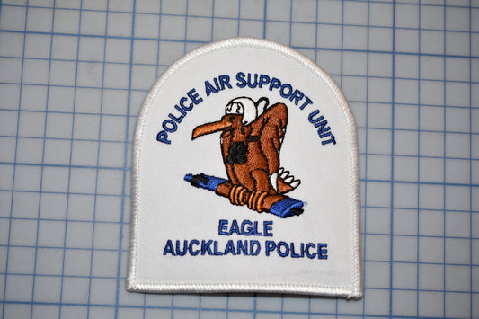 a police air support unit patch with an eagle, specifically an Auckland police eagle, as the main design element.