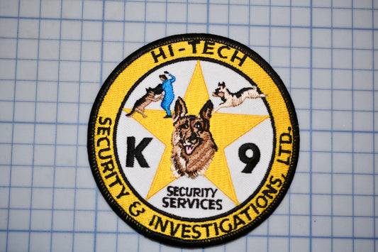 a circular patch with a yellow border, containing an embroidered design and text.