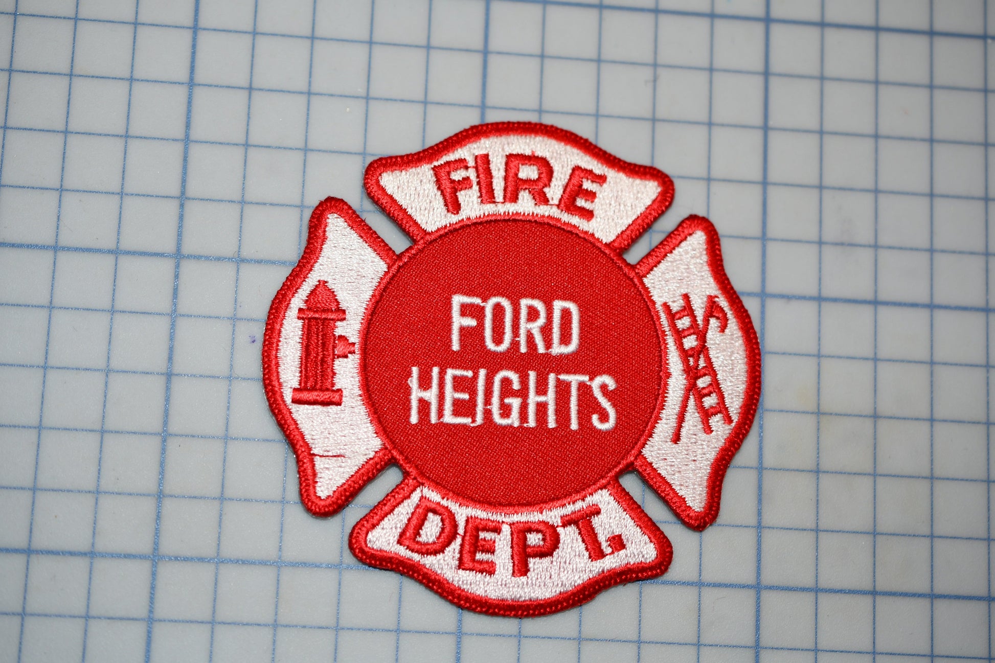 a red and white fire department patch with the text "FIRE" and "DEPT."