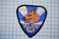 A police dog patch with the text "DINO" and "SALI RIVER POLICE K-9 UNIT" on it.