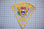 a patch with the text "MONROE 1823" and "ANIMAL CONTROL" on it, along with an eagle and a shield.