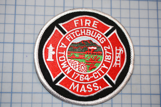 a circular patch with a red border and white text, which appears to be a patch related to the fire department of a town.