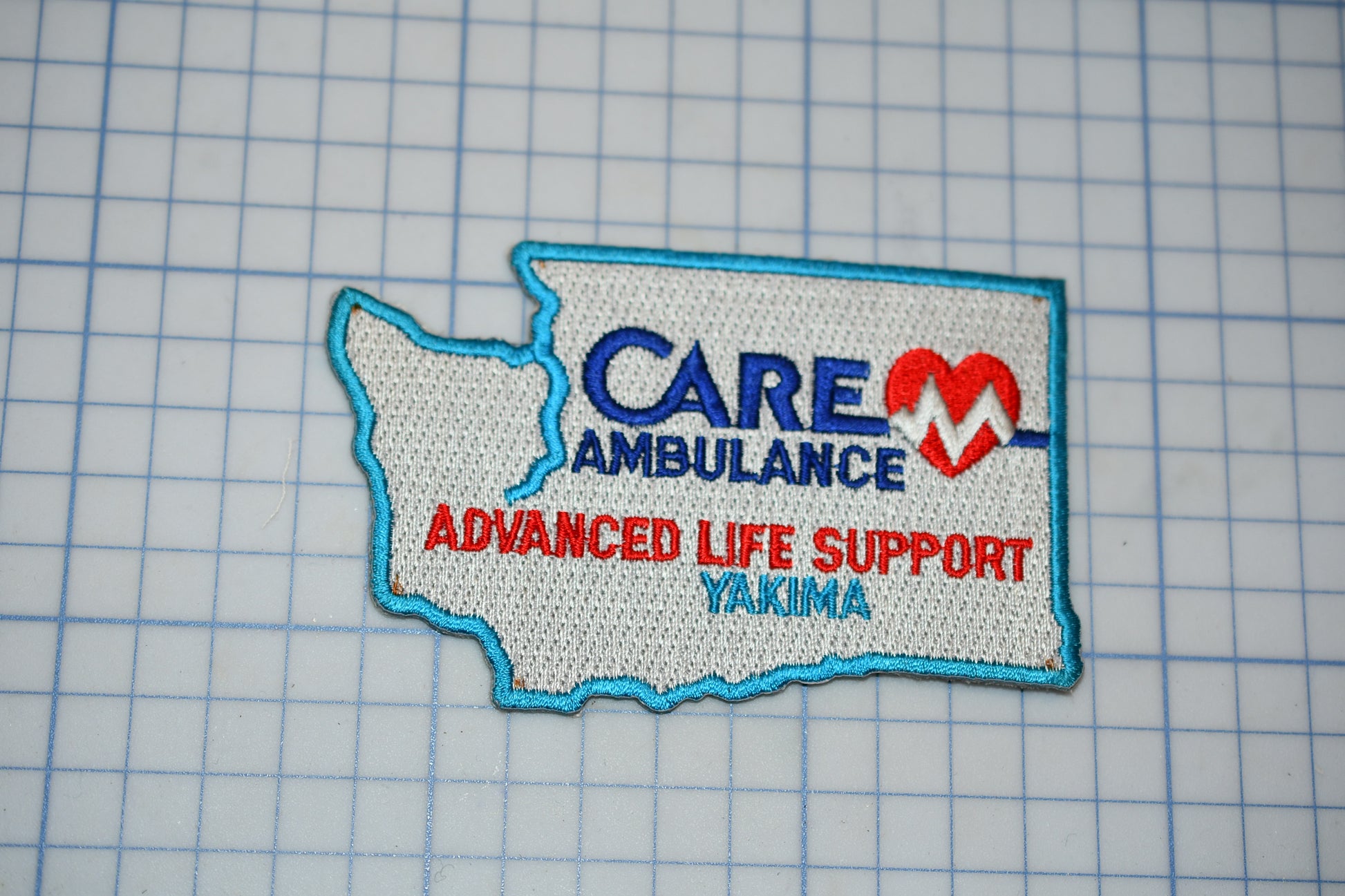 a patch with the text "Care Ambulance Advanced Life Support Yakima" on it, along with a heart symbol.