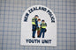 a patch with the text "NEW ZEALAND POLICE Youth Unit" and an illustration of three police officers.