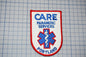 a patch with the text "CARE PARAMEDIC SERVICES PORTLAND" and a medical symbol, likely representing a healthcare organization or institution.