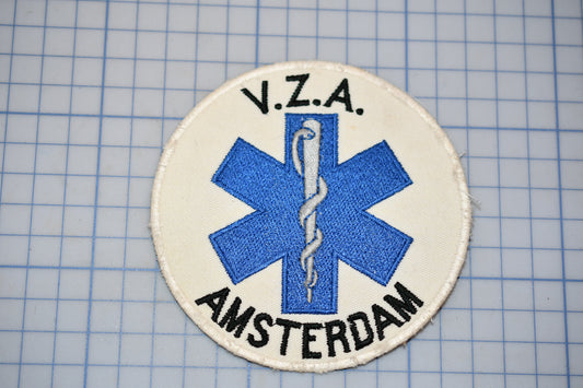 a circular patch with a blue medical symbol and text, placed on a grid background.