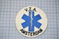 a circular patch with a blue medical symbol and text, placed on a grid background.