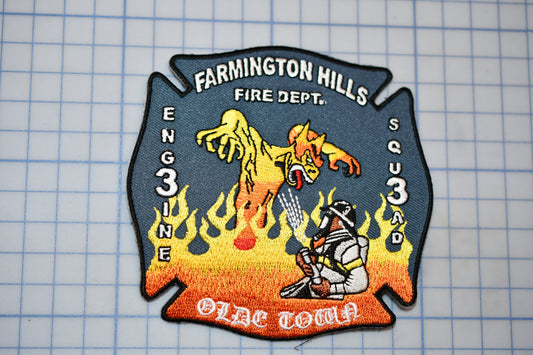 a fire department patch with a firefighter and a dragon, representing the Farmington Hills Fire Department.