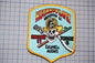 a patch with a stylized depiction of a firefighter and a skull, along with text that reads "House of Flame" and "Columbia Heights".