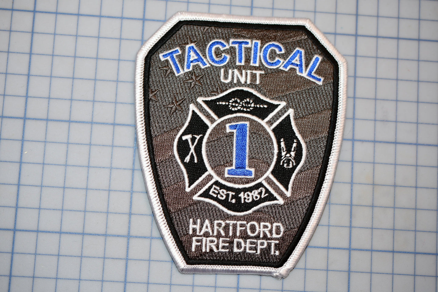 A fire department tactical unit patch with the number 1 and the words "TACTICAL UNIT" and "HARTFORD FIRE DEPT."
