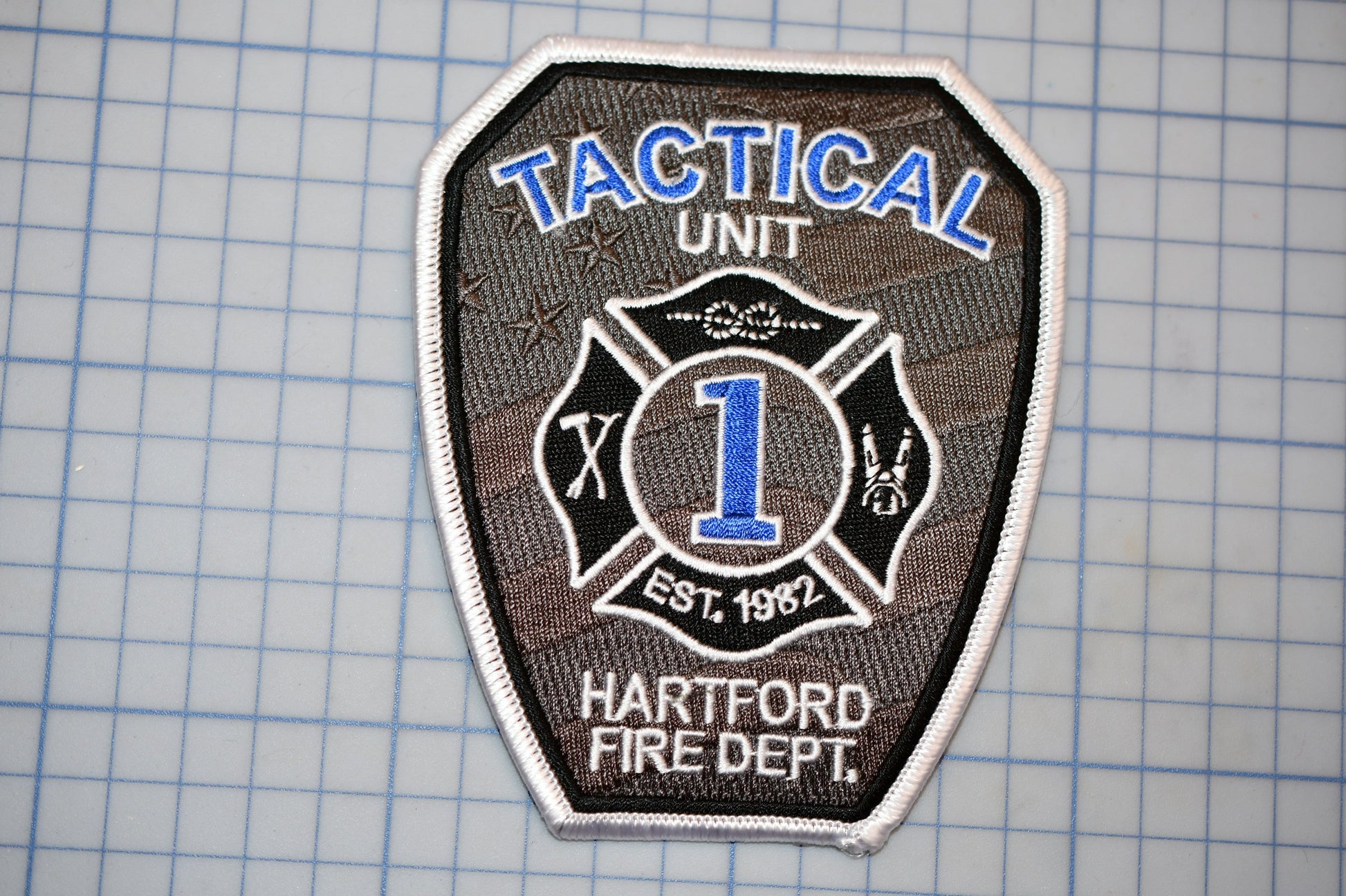 A fire department tactical unit patch with the number 1 and the words "TACTICAL UNIT" and "HARTFORD FIRE DEPT."