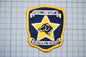 a badge with a dog on it, which is part of the Southwest Specialty Search and Rescue team.