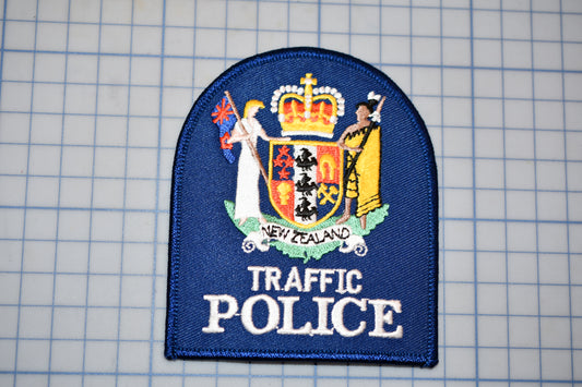 a blue patch with a coat of arms and text, representing the New Zealand Traffic Police.