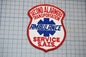 a red and white patch with the text "Second Ambulance Service" and "Ambulance Service S.A.T.S."