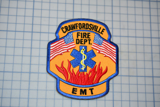 a fire department patch with the text "Crawfordsville Fire Dept. EMT" and an American flag design.