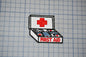a first aid kit with a red cross symbol on the lid, placed on a grid background.