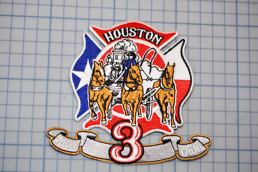 a patch with a fire department emblem, including a fire engine, horses, and a banner with the number 3.