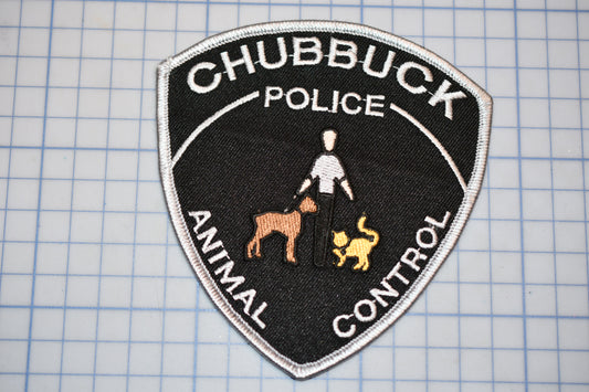 A police patch with the words "CHUBBUCK POLICE" and "ANIMAL CONTROL" printed on it, along with an image of a police officer and a dog.
