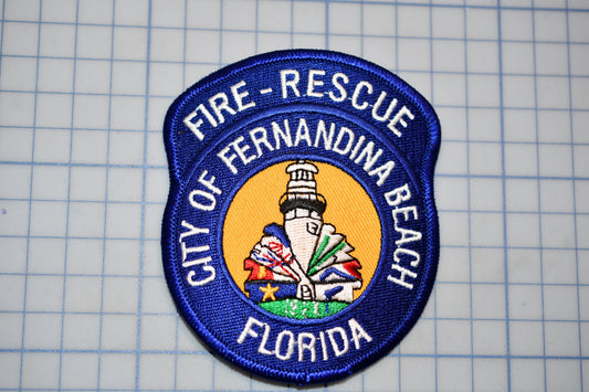a blue and white patch with the text "FIRE-RESCUE CITY OF FERNANDINA BEACH FLORIDA" on it.