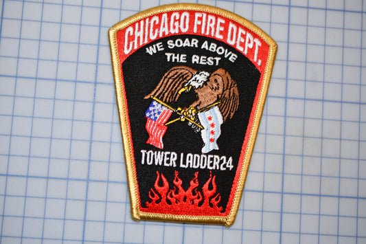 a Chicago Fire Department patch with a black background, a red border, and a gold border. The patch displays an eagle holding a flag, and the text "CHICAGO FIRE DEPT. WE SOAR ABROVE THE REST. TOWER LADDER24" is written on it.