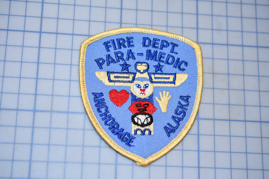 a blue and gold badge with text and a graphic, placed on a blue grid background.