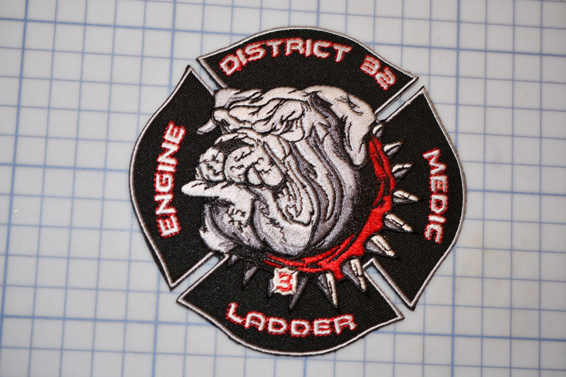 a fire department patch with a bulldog emblem, surrounded by text that identifies the department's specialty.