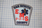 a patch with the text "SAN BENITO EMS COUNTY" and a medical symbol, likely representing the emergency medical services of San Benito County.