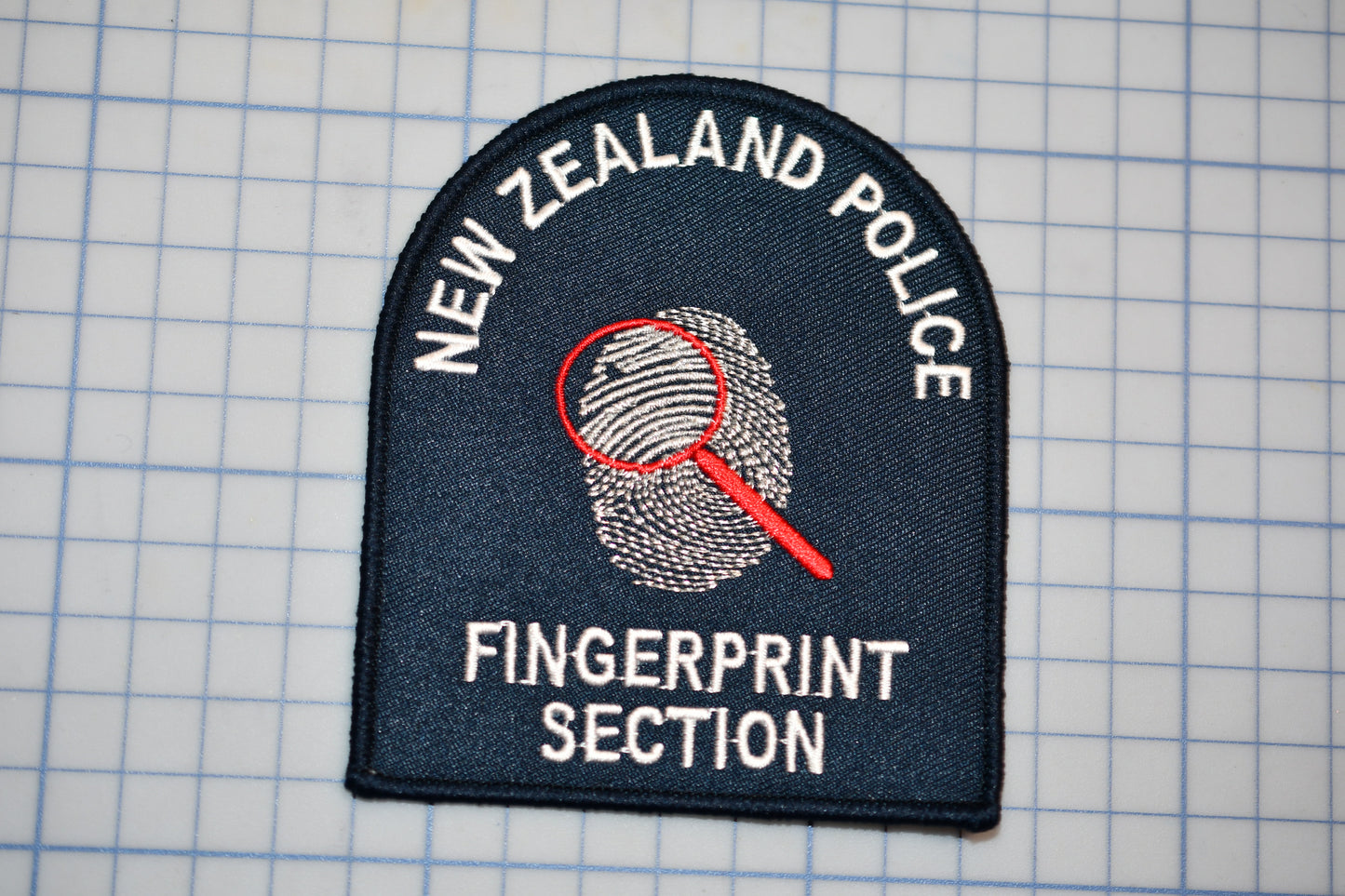 a New Zealand Police fingerprint section patch.