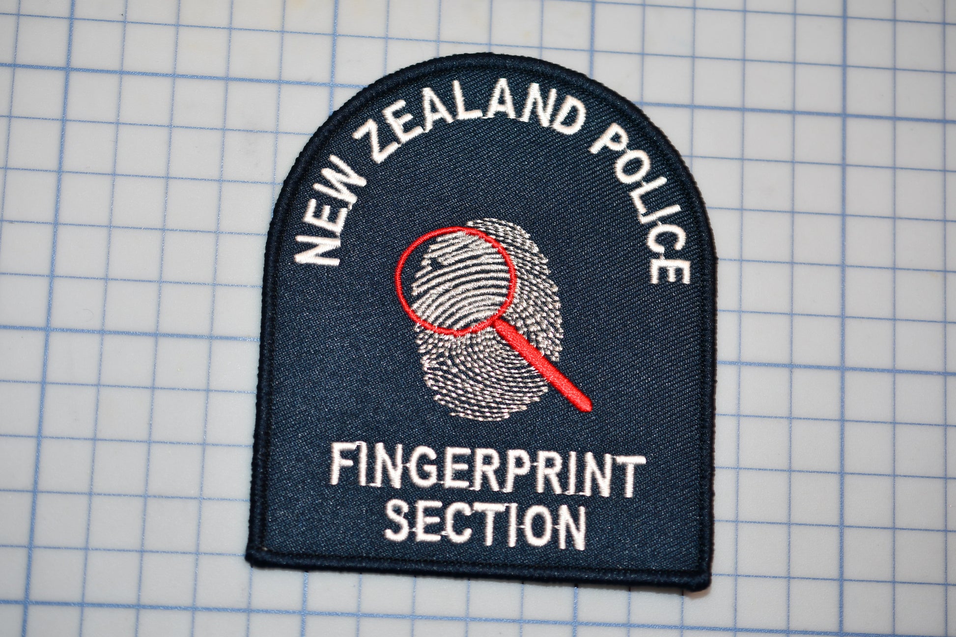 a New Zealand Police fingerprint section patch.