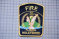 a fire department patch with the text "FIRE EST. 1987 ALABAMA HOLLYWOOD" and an eagle emblem.
