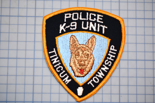 a police K-9 unit patch with a dog's head and the text "Police K-9 Unit" and "Township" on it.