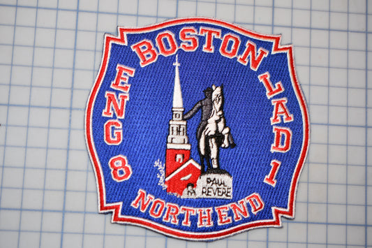 a blue and red badge with the text "BOSTON LADI NORTHEND" and an illustration of a building and a person.