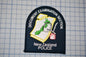 a black and white patch with text and an emblem, likely representing the New Zealand Police.