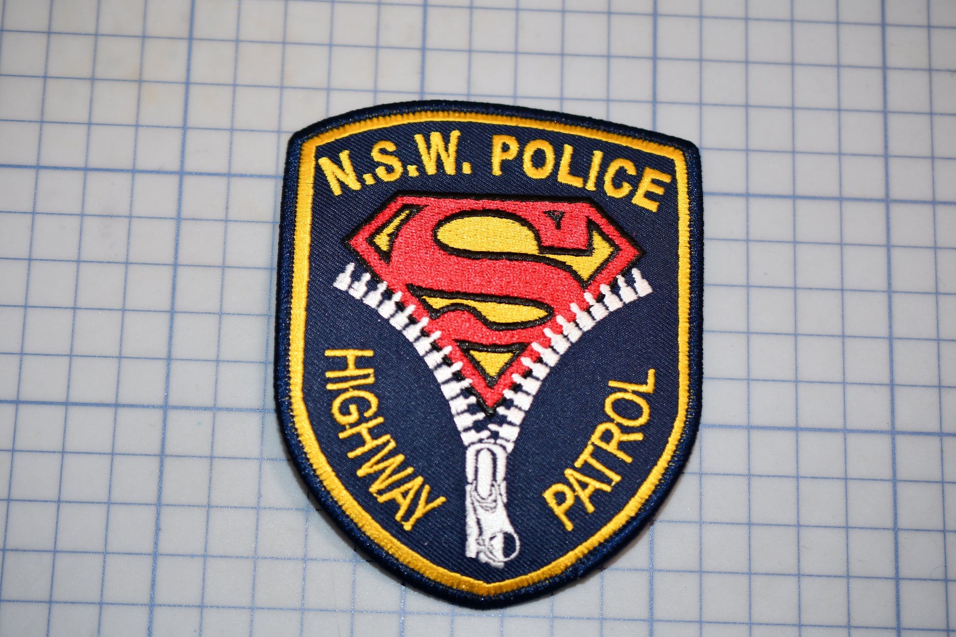 a police patch with a Superman logo, indicating that it is a Highway Patrol police patch.