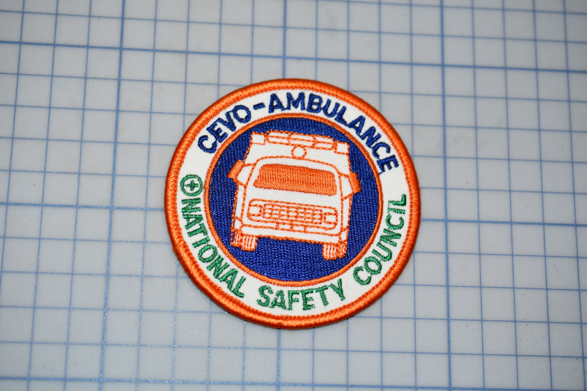 a patch with the text "CEVO-AMBULANCE" and "NATIONAL SAFETY COUNCIL" printed on it, along with an image of an ambulance.